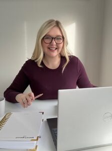 Smiling woman working at her laptop desk.
